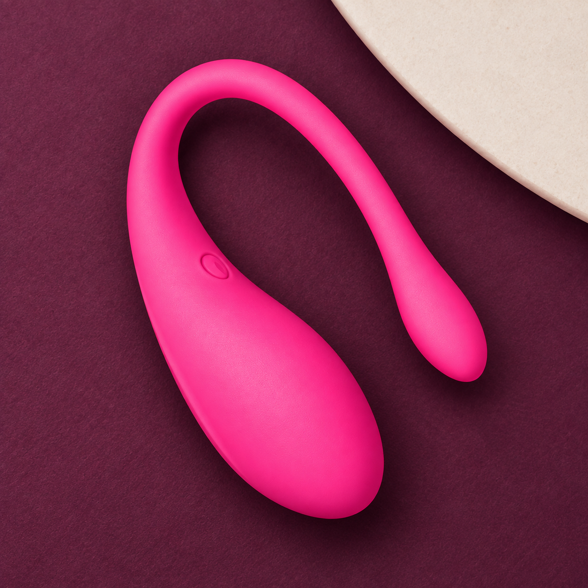 App-controlled wearable device — bright pink KINKZA top view
